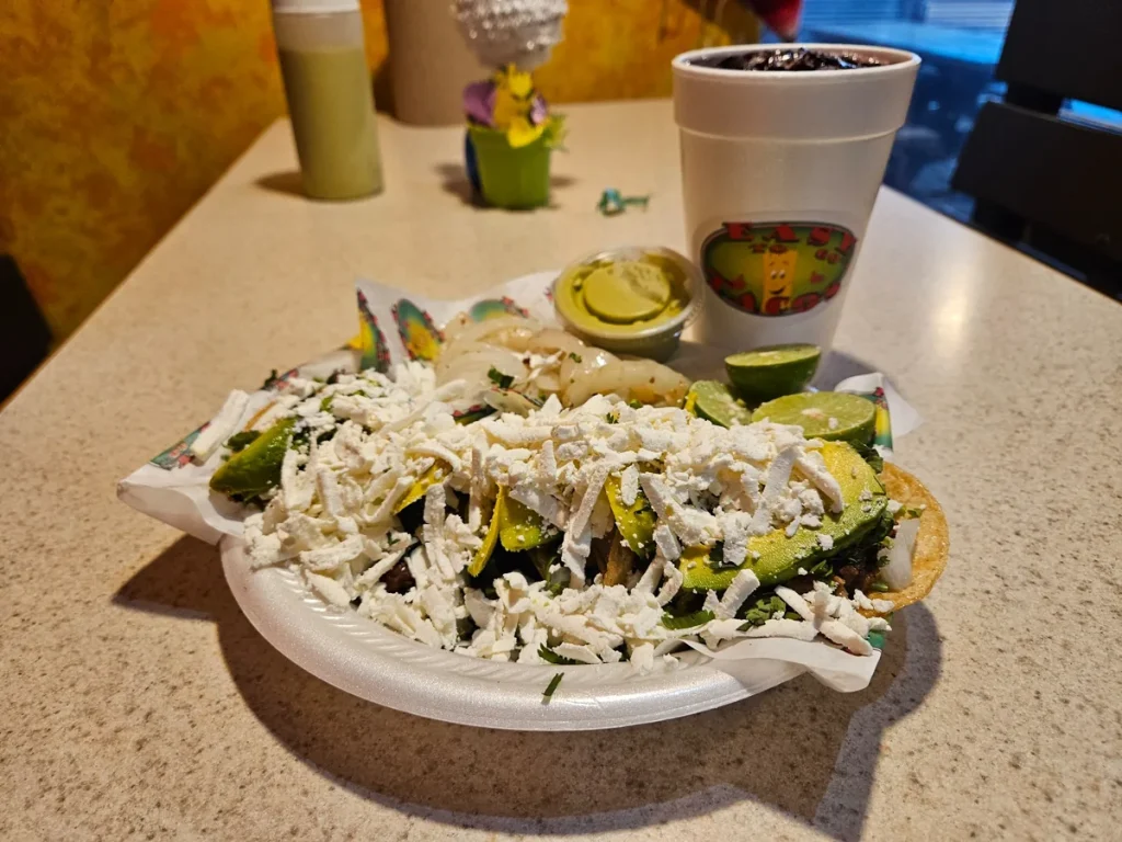 Mexican tacos topped with avocado, shredded cheese and fresh ingredients at Easy To Go Tacos in Brownsville, TX.