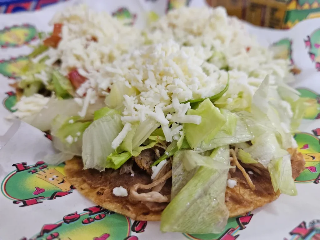 Mexican food in Brownsville, TX at Easy To Go Tacos featuring tostadas topped with shredded lettuce, cheese and meat.